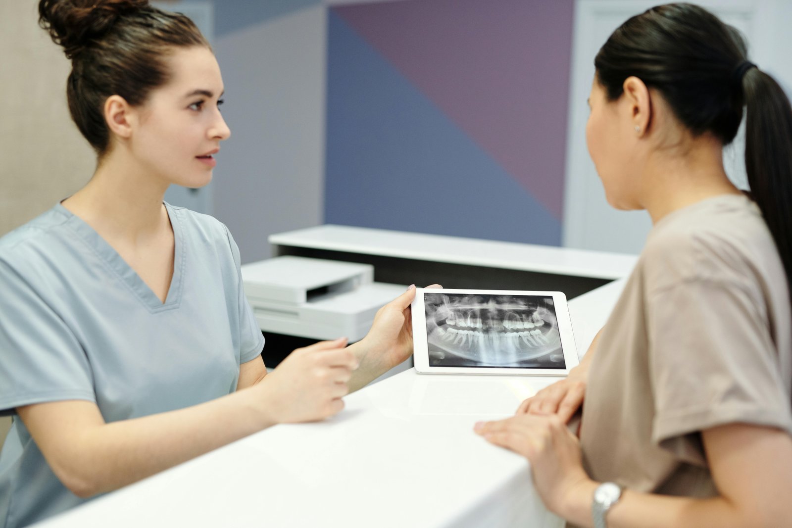 Dentist applying a cosmetic filling to a patient's tooth